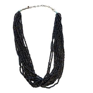Multi-strand deep purple breaded necklace.